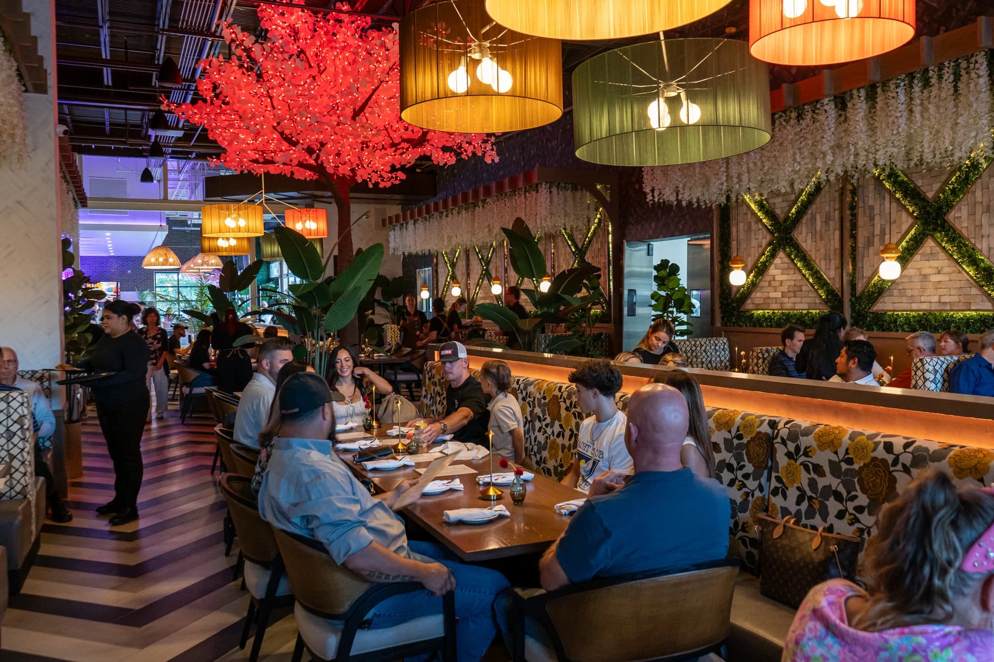 A full dining room at Suwanee Social at night, every table taken