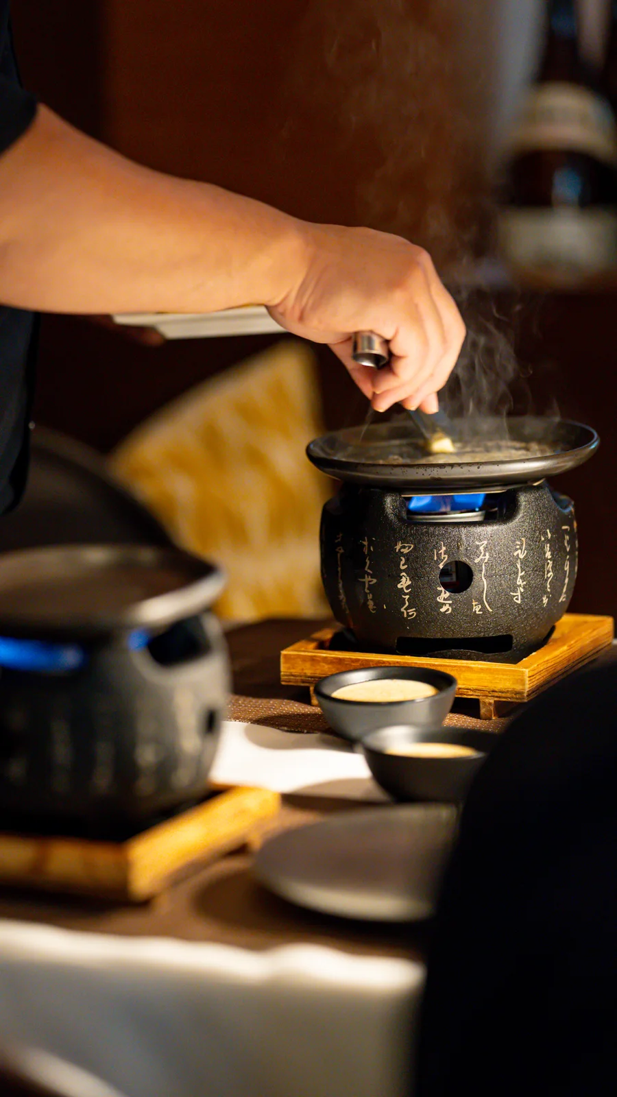 The lid lifted off a toban of A5 wagyu at Tomo Japanese, steam rising