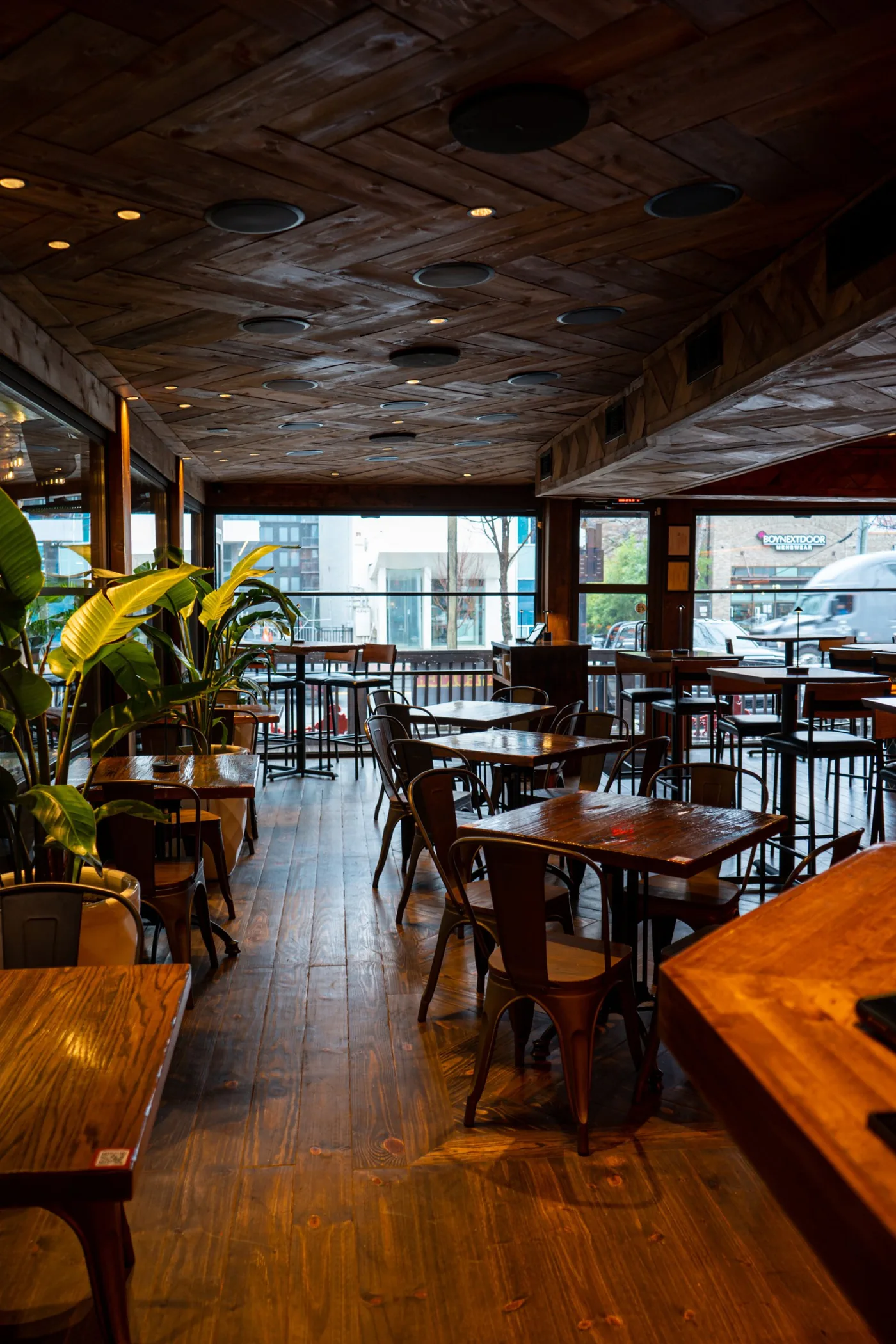 The Zócalo dining room under its wood ceiling, with windows onto the street