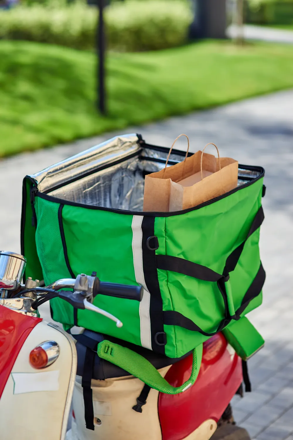Delivery courier handing off an order at a restaurant
