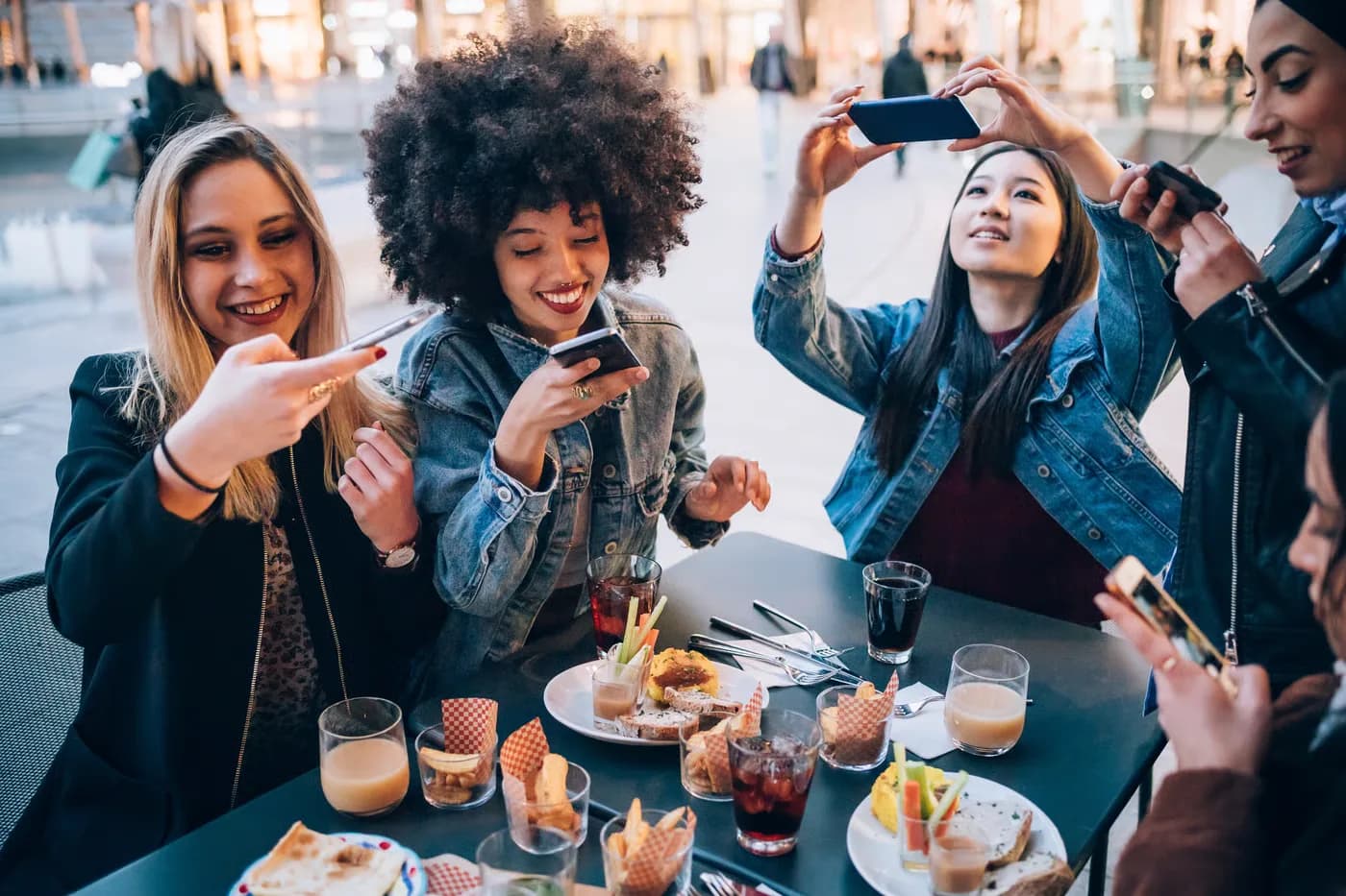 Creator capturing a plated dish at a local restaurant table